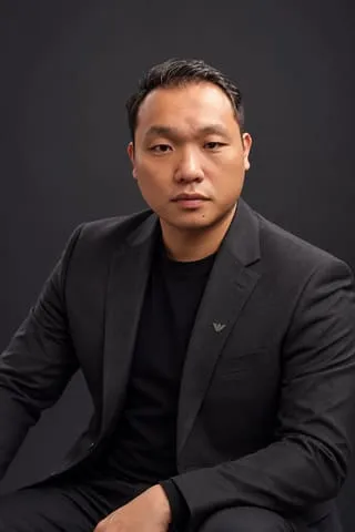 AI-generated studio portrait of George Oo, made at AI Odyssey, September 2026